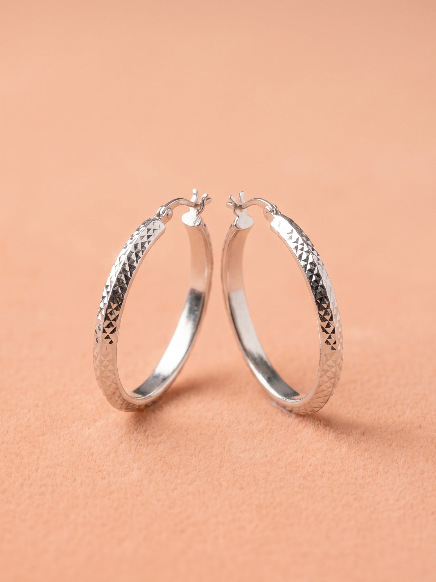 Faceted Diamond-Cut Oval Hoop Earrings