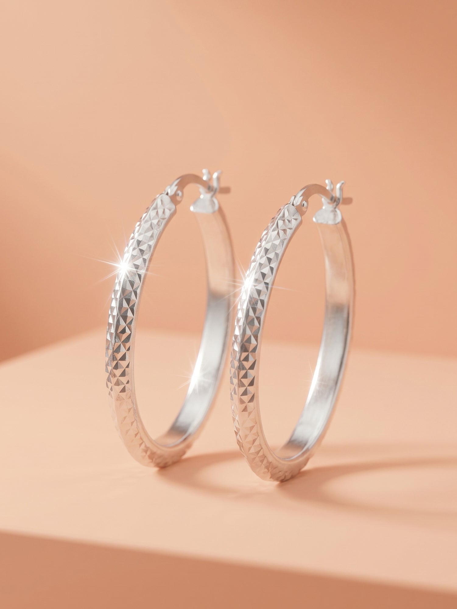 Faceted Diamond-Cut Oval Hoop Earrings