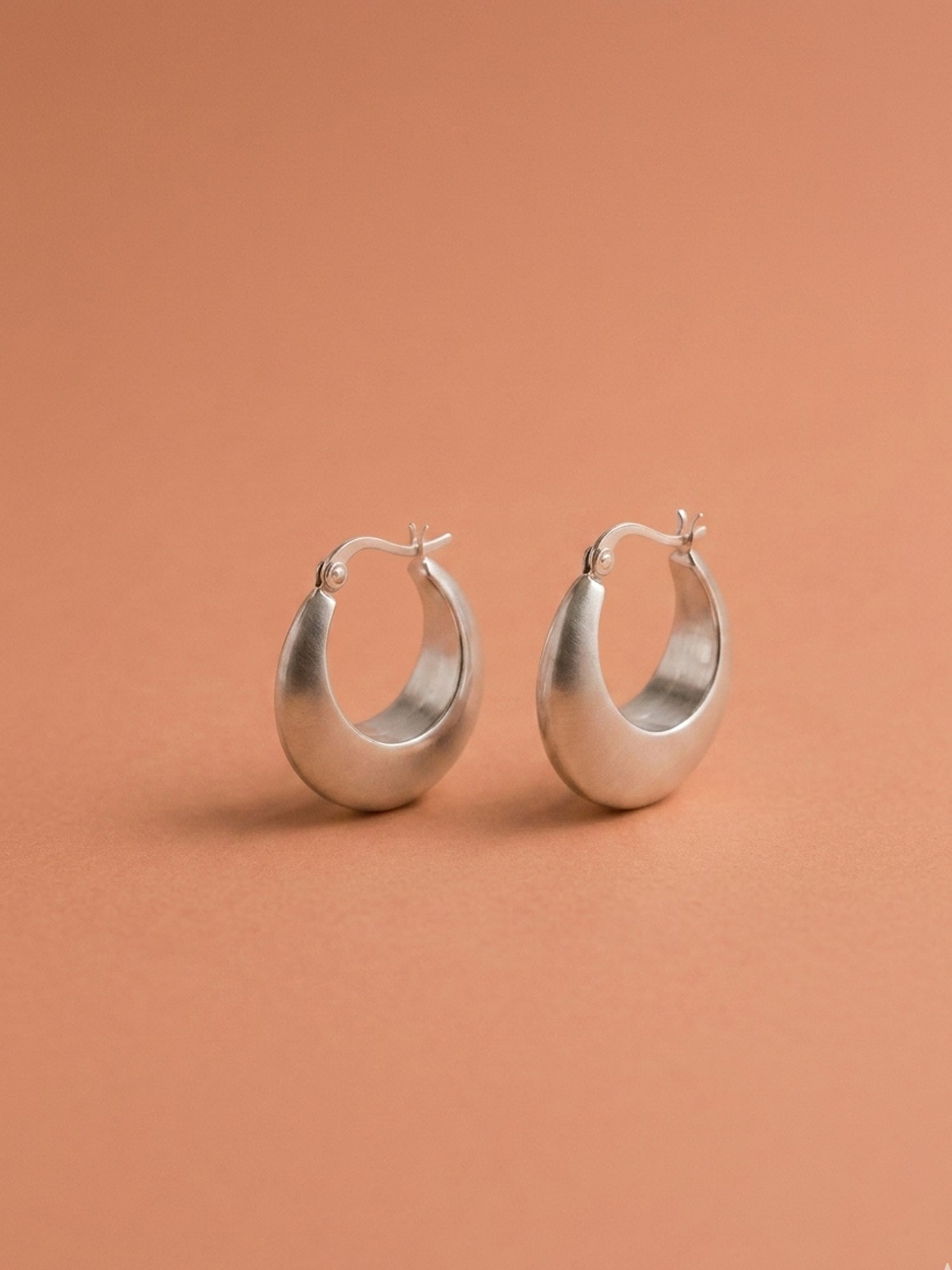 Sleek Silver Crescent Hoops
