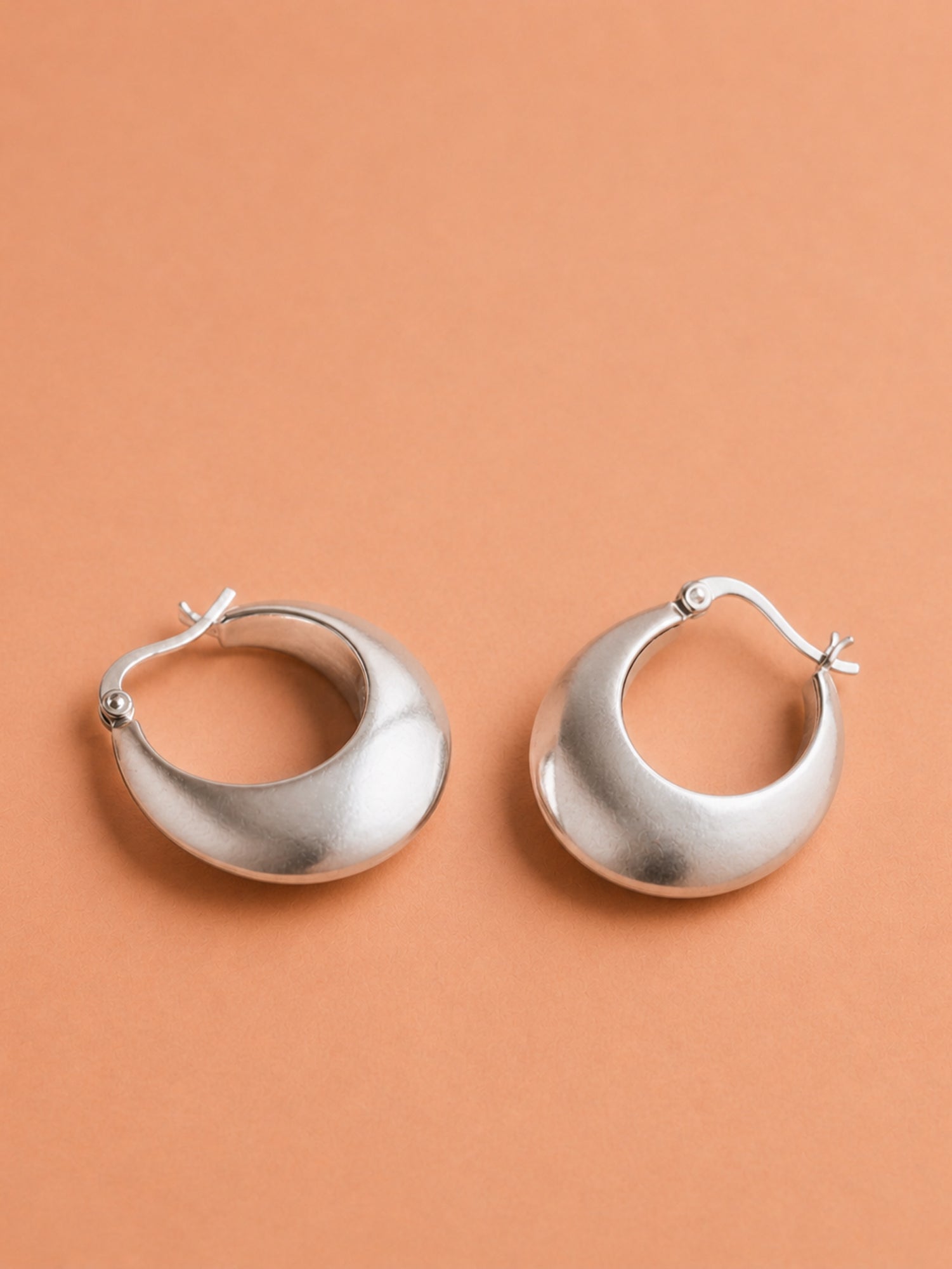 Sleek Silver Crescent Hoops