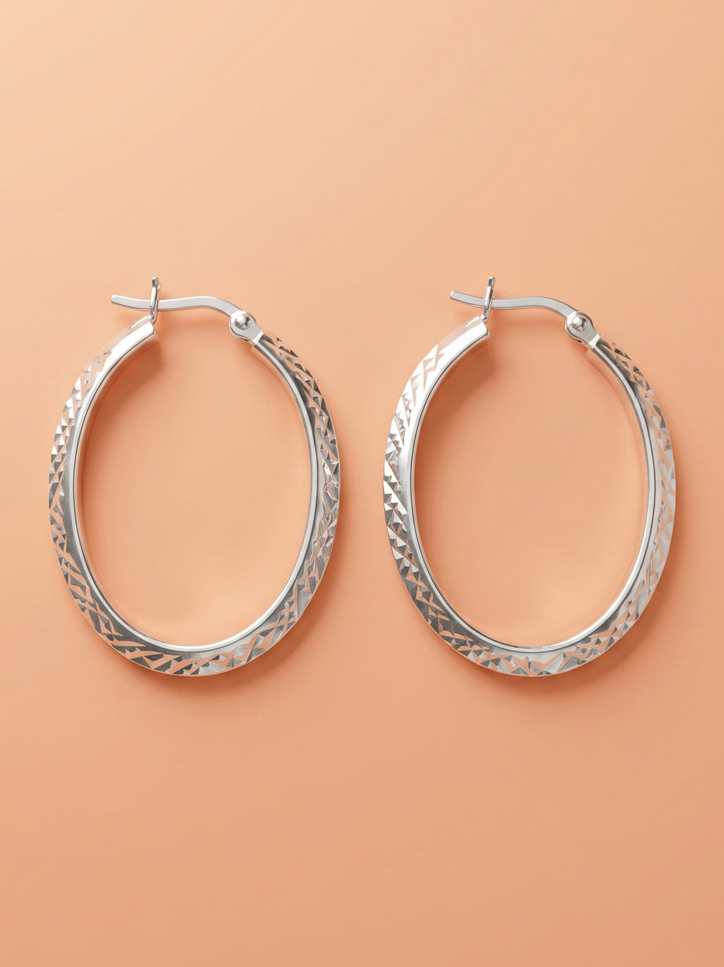 Faceted Diamond-Cut Oval Hoop Earrings