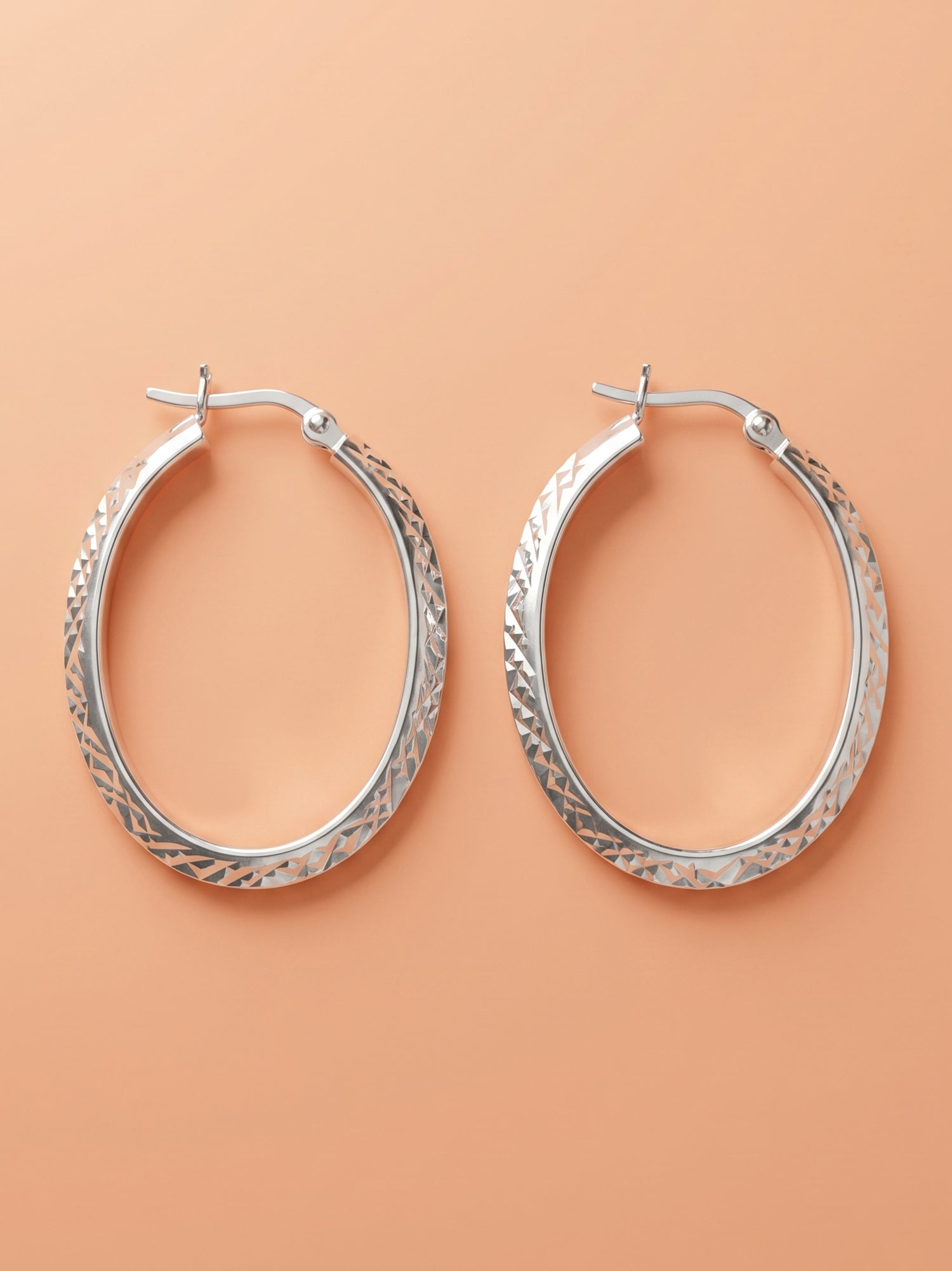 Faceted Diamond-Cut Oval Hoop Earrings